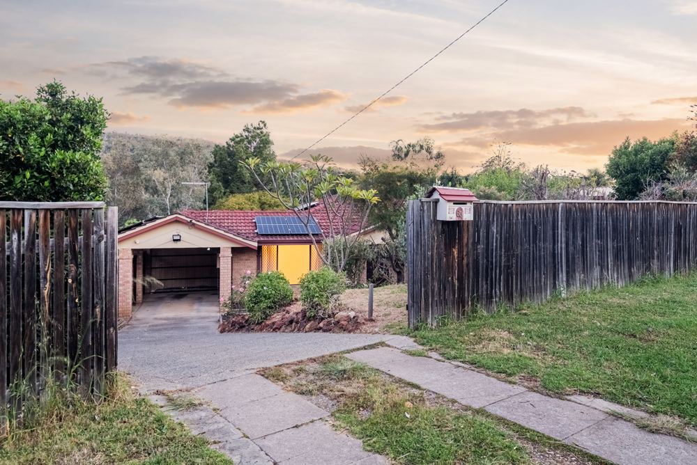 Front of a brick home in Mount Richon at dusk